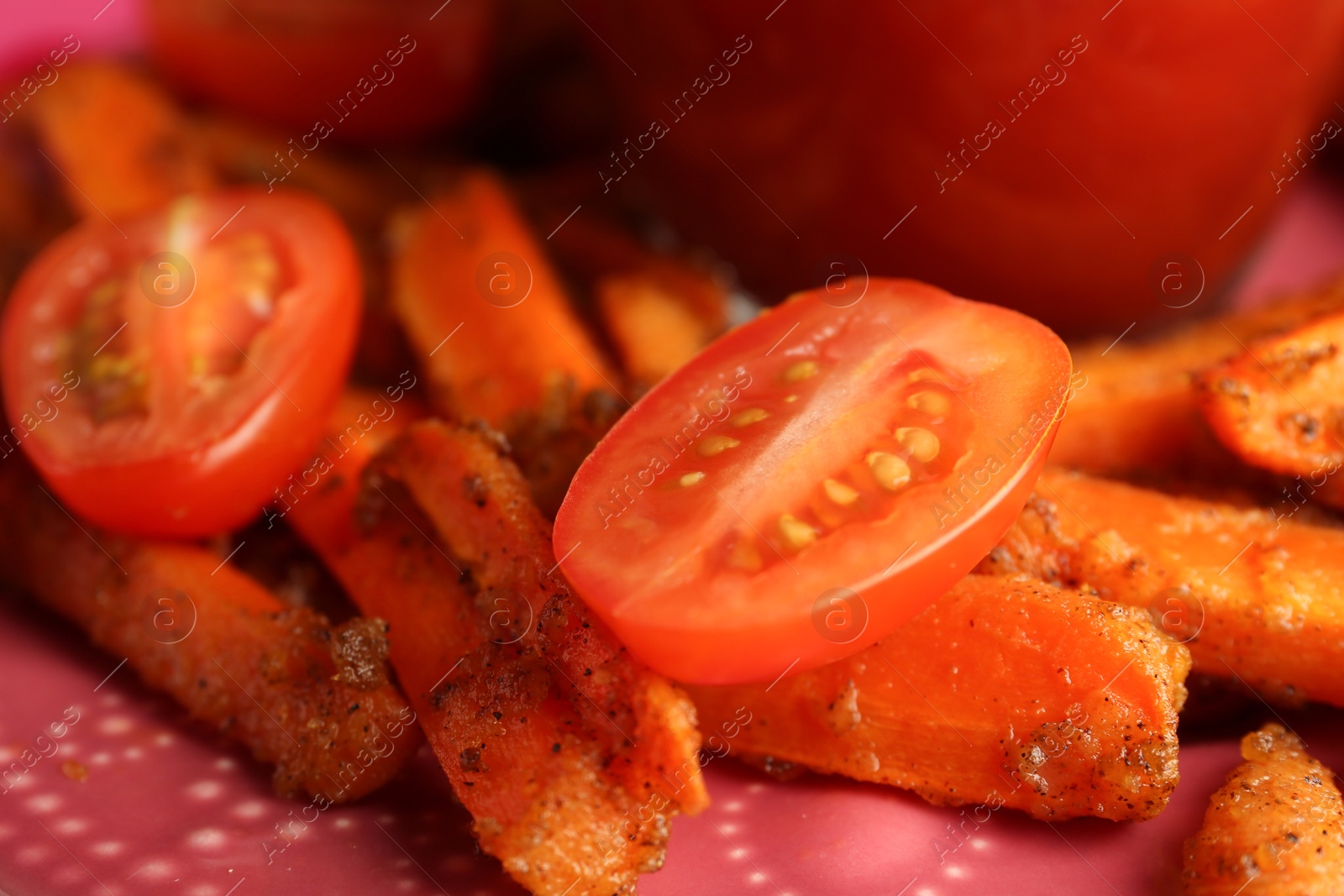 Photo of Tasty ketchup, tomatoes and fried carrots on plate, closeup