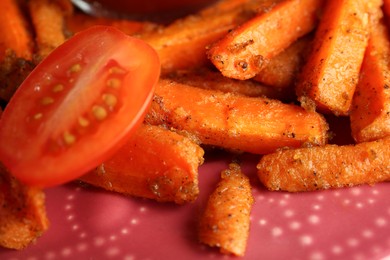 Photo of Tasty ketchup, tomatoes and fried carrots on plate, closeup