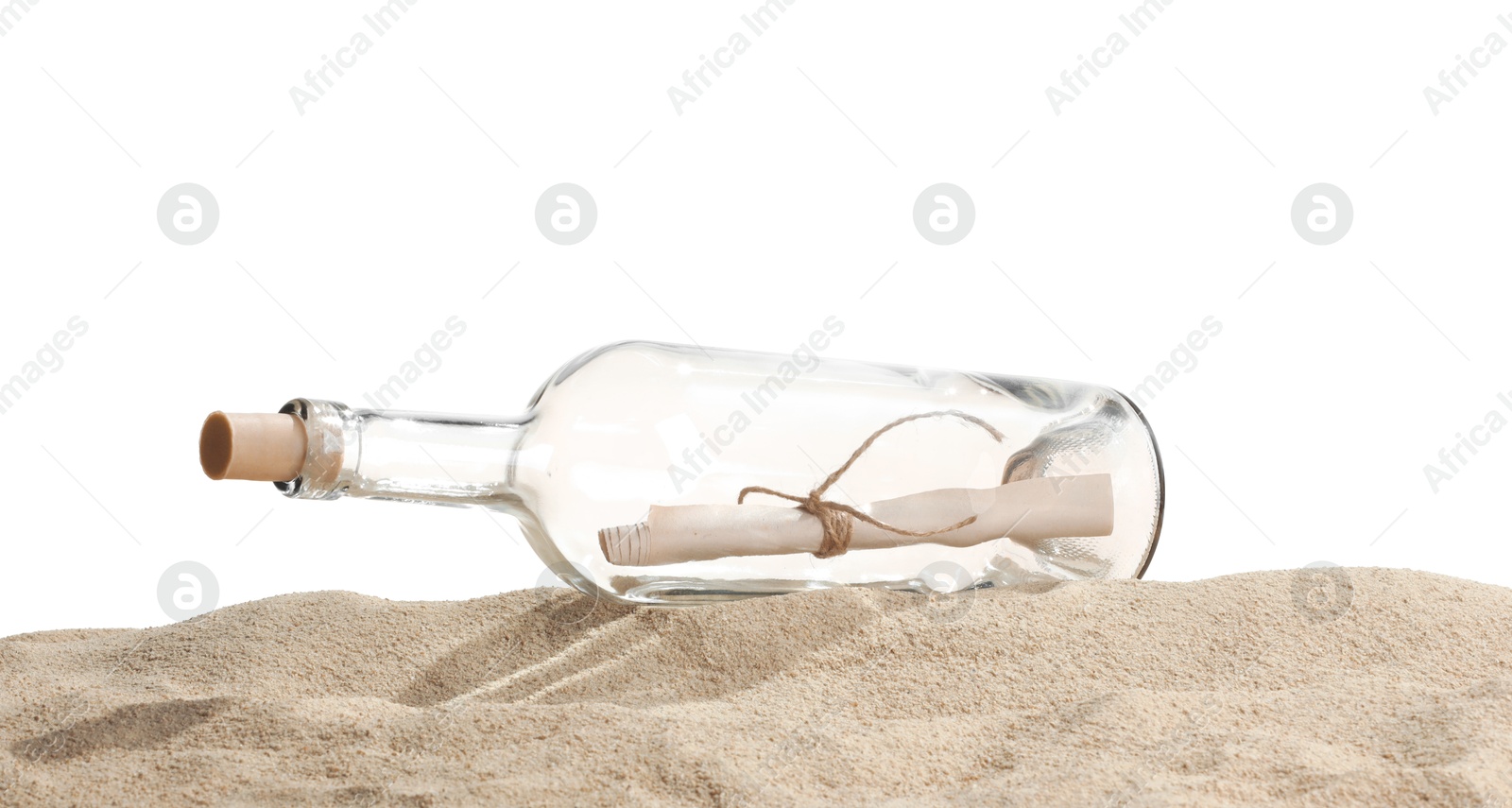 Photo of Rolled letter in corked glass bottle on sand against white background