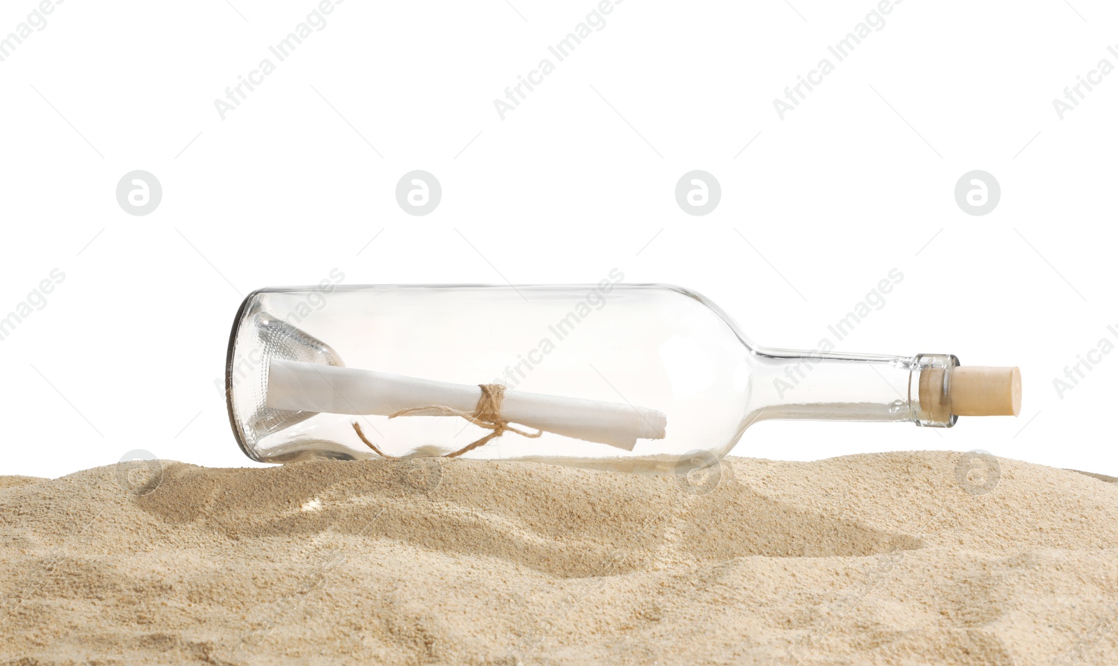 Photo of Rolled letter in corked glass bottle on sand against white background