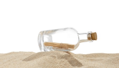 Photo of Rolled letter in corked glass bottle on sand against white background