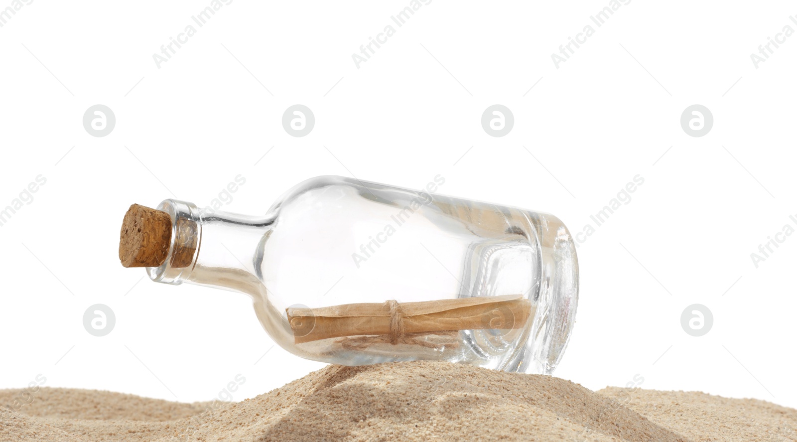 Photo of Rolled letter in corked glass bottle on sand against white background