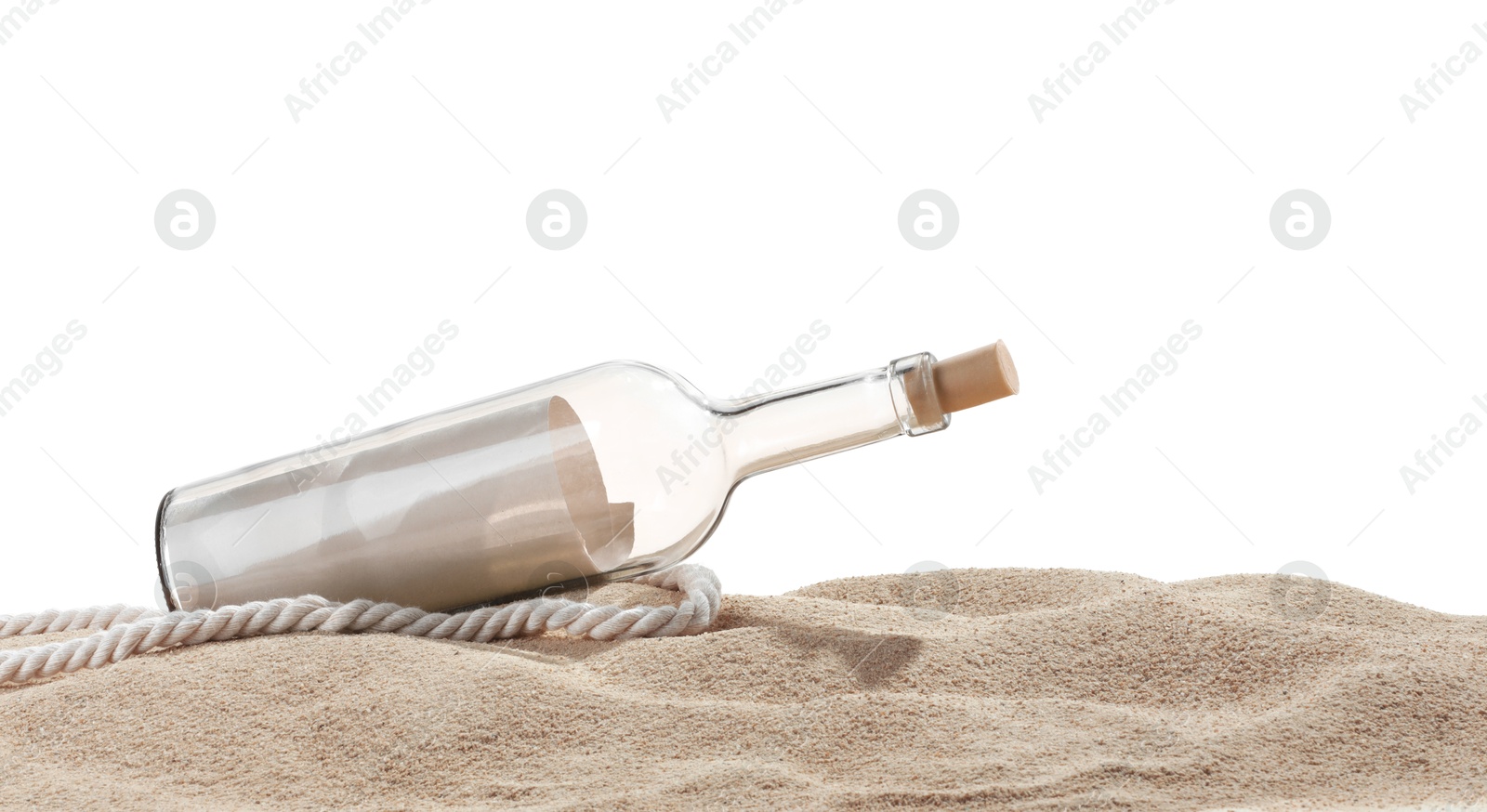 Photo of Rolled letter in corked glass bottle and rope on sand against white background