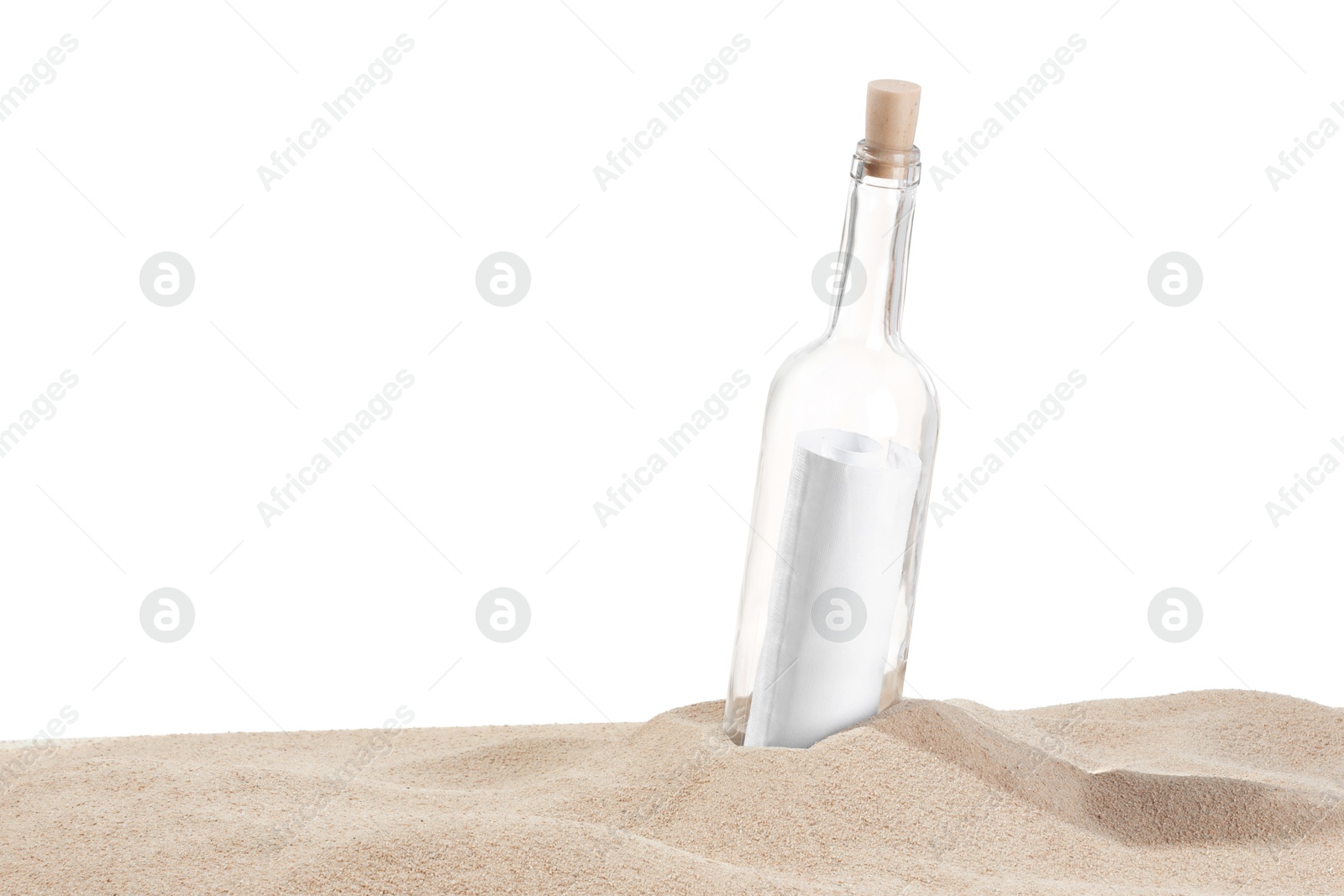 Photo of Rolled letter in corked glass bottle on sand against white background