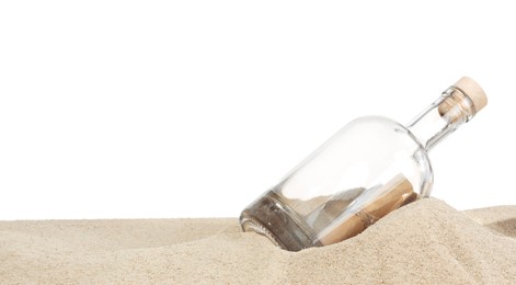 Photo of Rolled letter in corked glass bottle on sand against white background