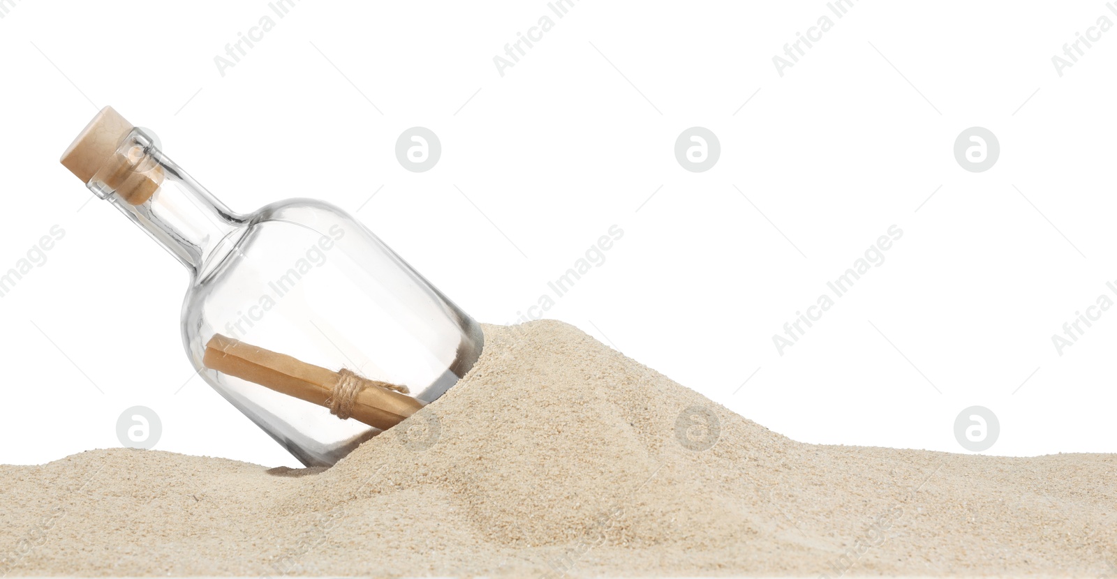 Photo of Rolled letter in corked glass bottle on sand against white background