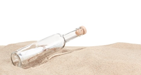 Photo of Rolled letter in corked glass bottle on sand against white background