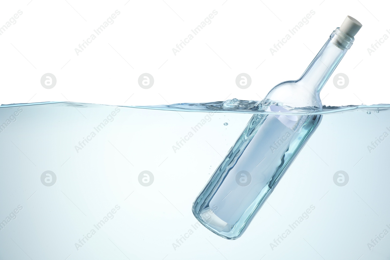 Photo of Corked glass bottle with rolled letter in water on white background