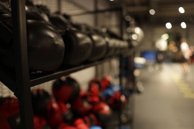 Photo of Different sport equipment on shelfs in training center, closeup. Space for text