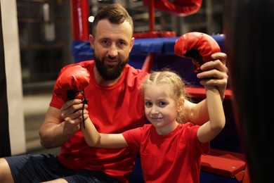 Photo of Happy girl with her coach near boxing ring