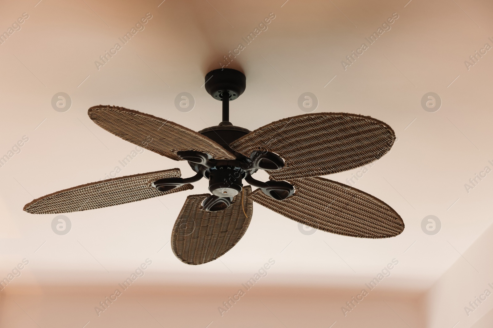 Photo of Modern ceiling fan indoors, low angle view