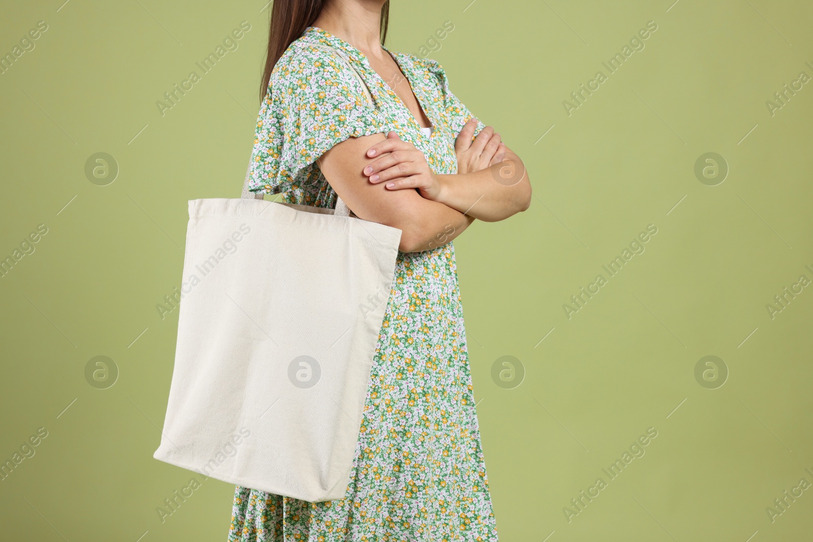 Photo of Woman with blank shopper bag on color background, closeup. Mockup for design