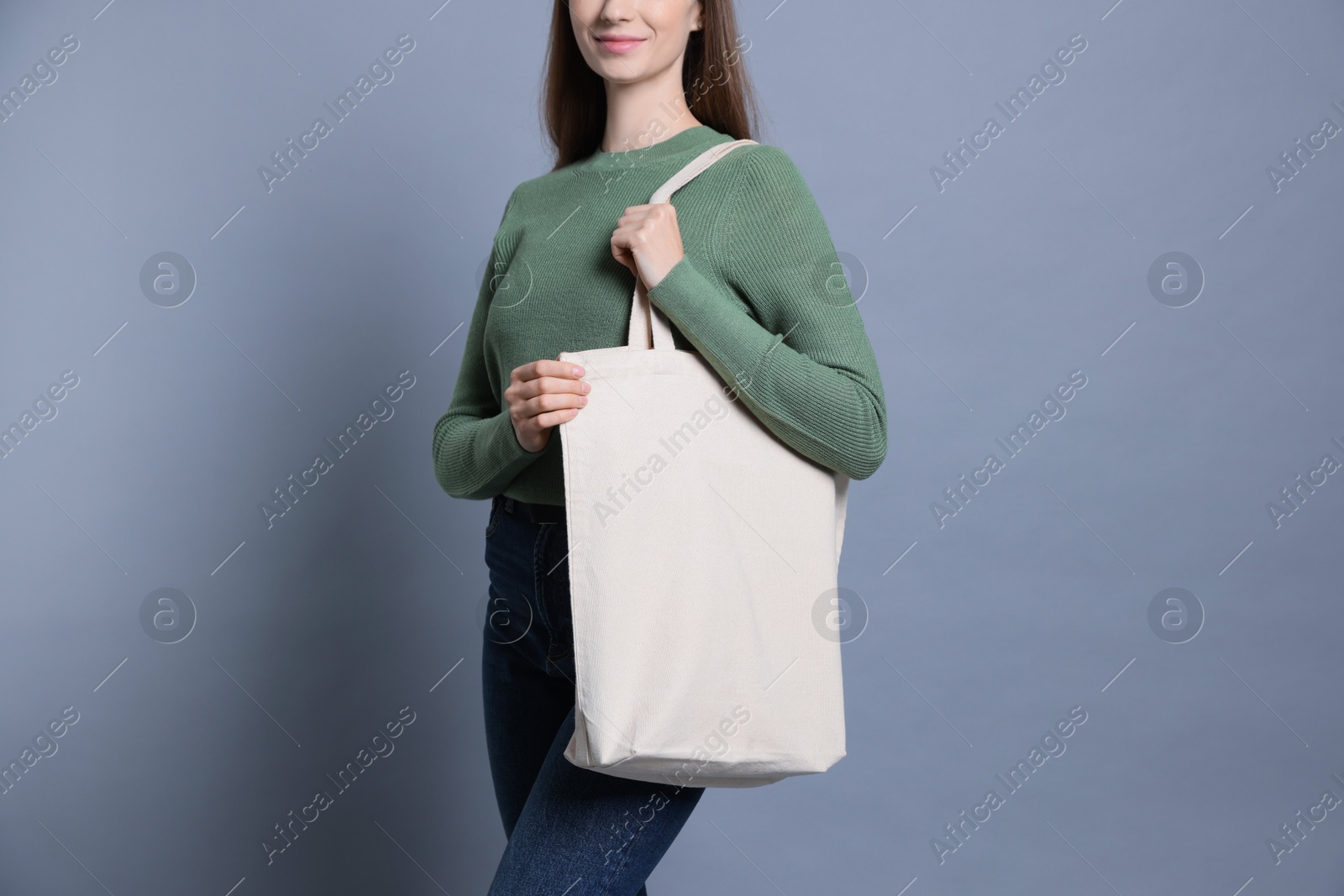 Photo of Woman with blank shopper bag on grey background, closeup. Mockup for design