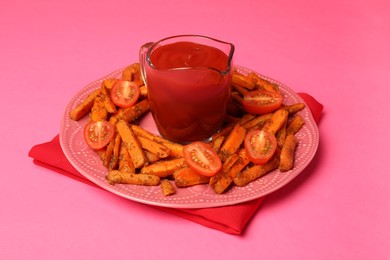 Photo of Tasty ketchup, tomatoes and fried carrots on pink background