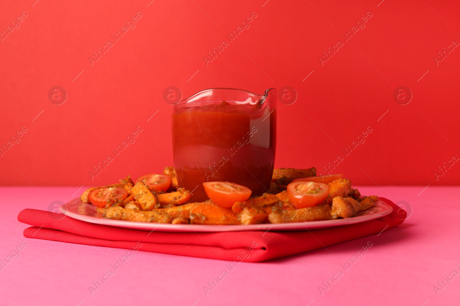 Photo of Tasty ketchup, tomatoes and fried carrots on color background