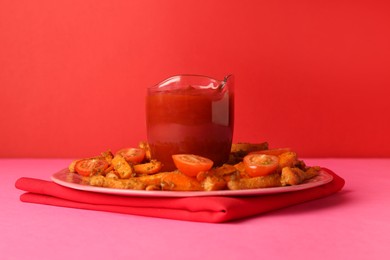 Photo of Tasty ketchup, tomatoes and fried carrots on color background