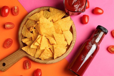 Photo of Tasty ketchup, tomatoes and nachos on color background, flat lay