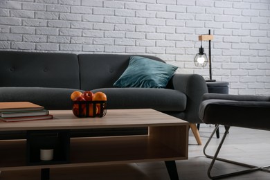 Photo of Comfortable sofa, armchair and coffee table in living room. Interior design