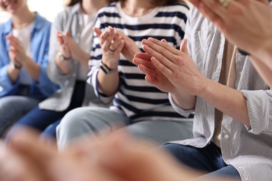 Photo of People applauding during meeting indoors, closeup view