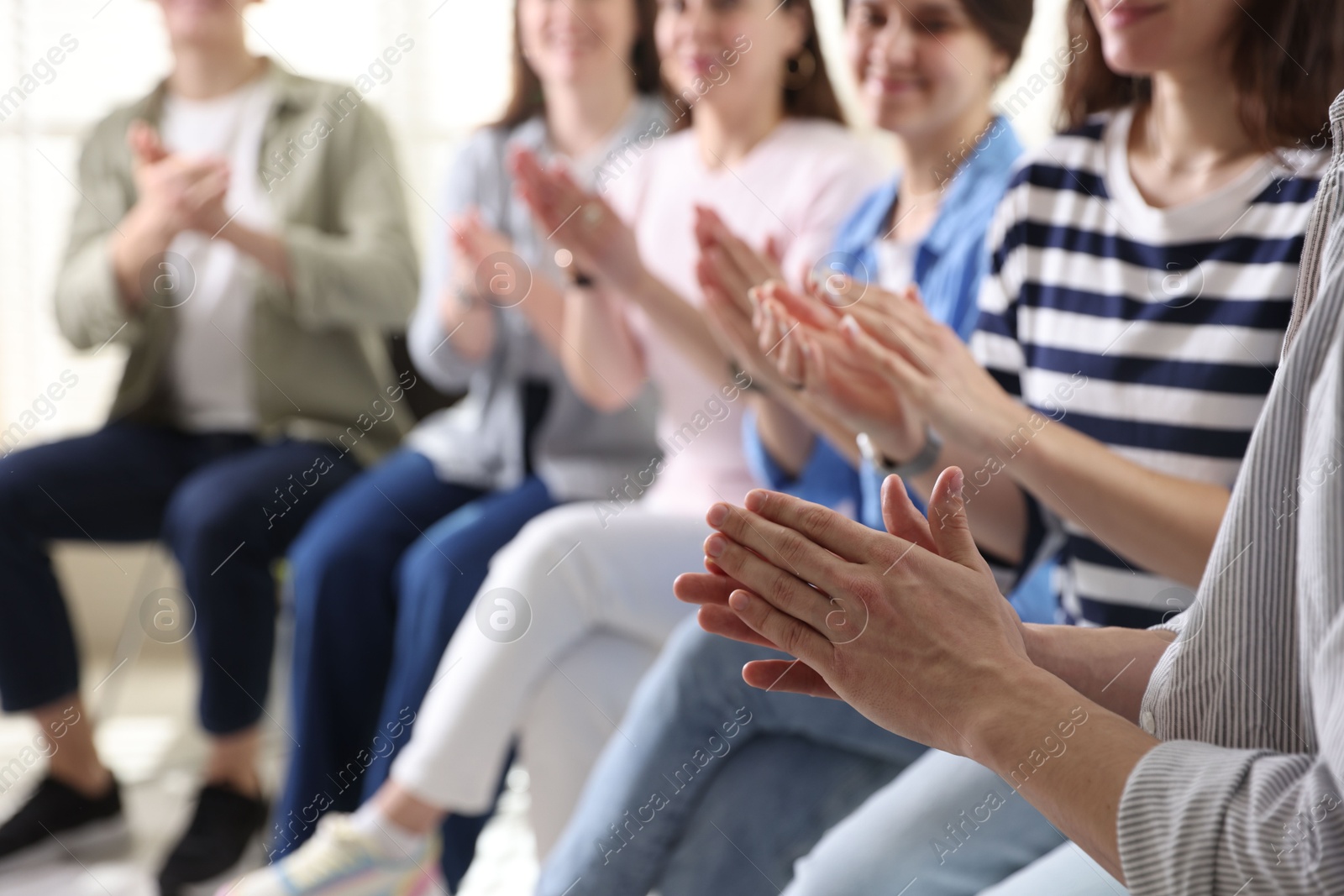 Photo of People applauding during meeting indoors, closeup view