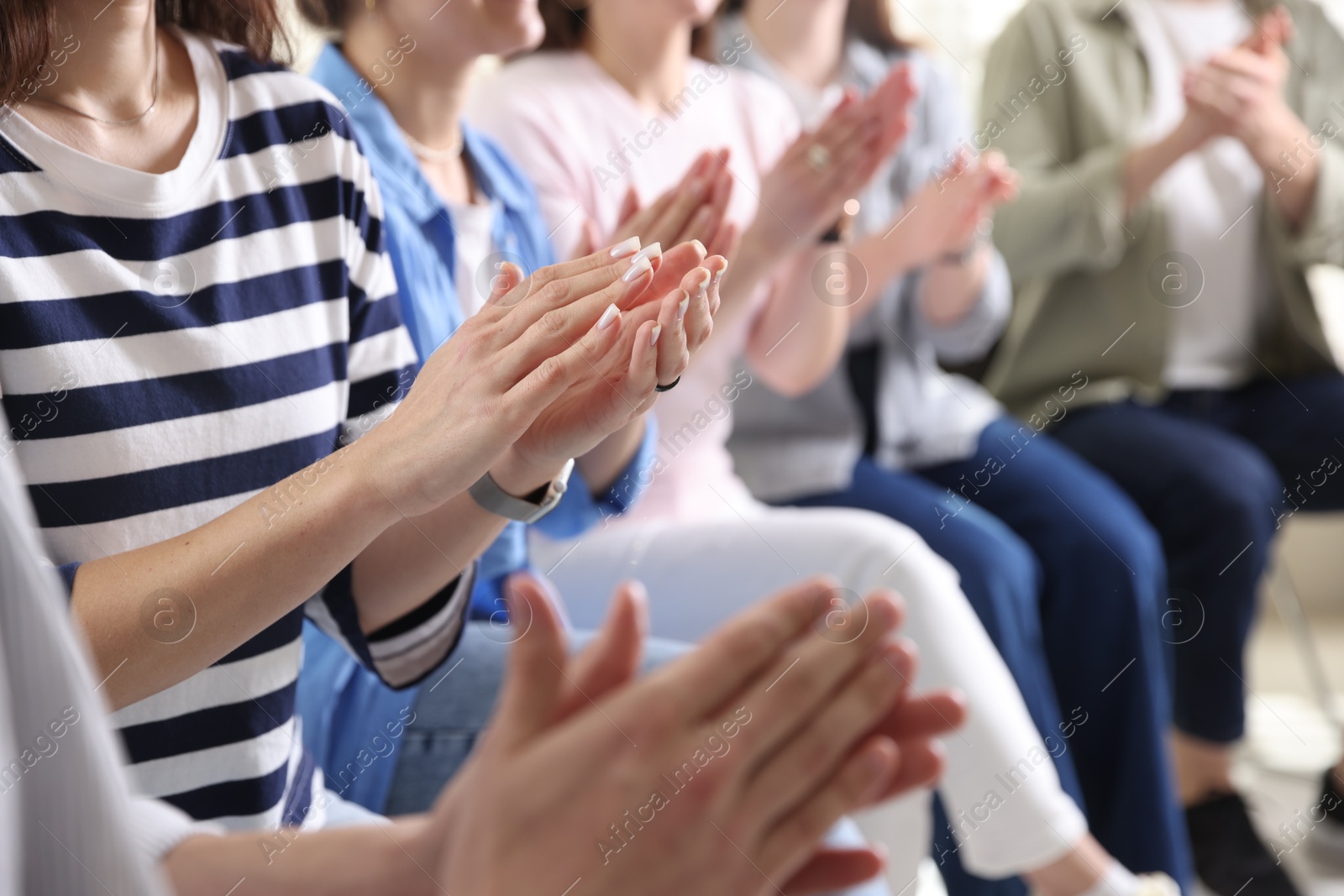 Photo of People applauding during meeting indoors, closeup view