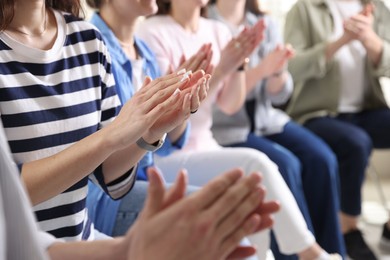 Photo of People applauding during meeting indoors, closeup view