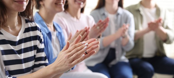 Photo of People applauding during meeting indoors, closeup view