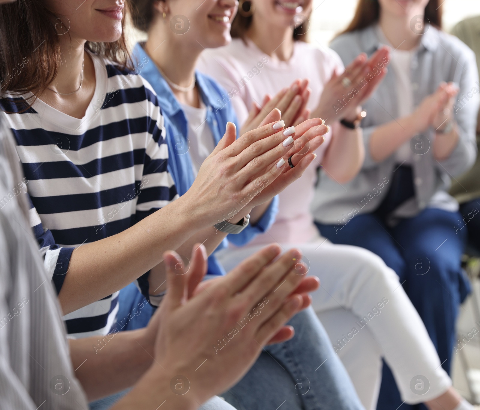 Photo of People applauding during meeting indoors, closeup view