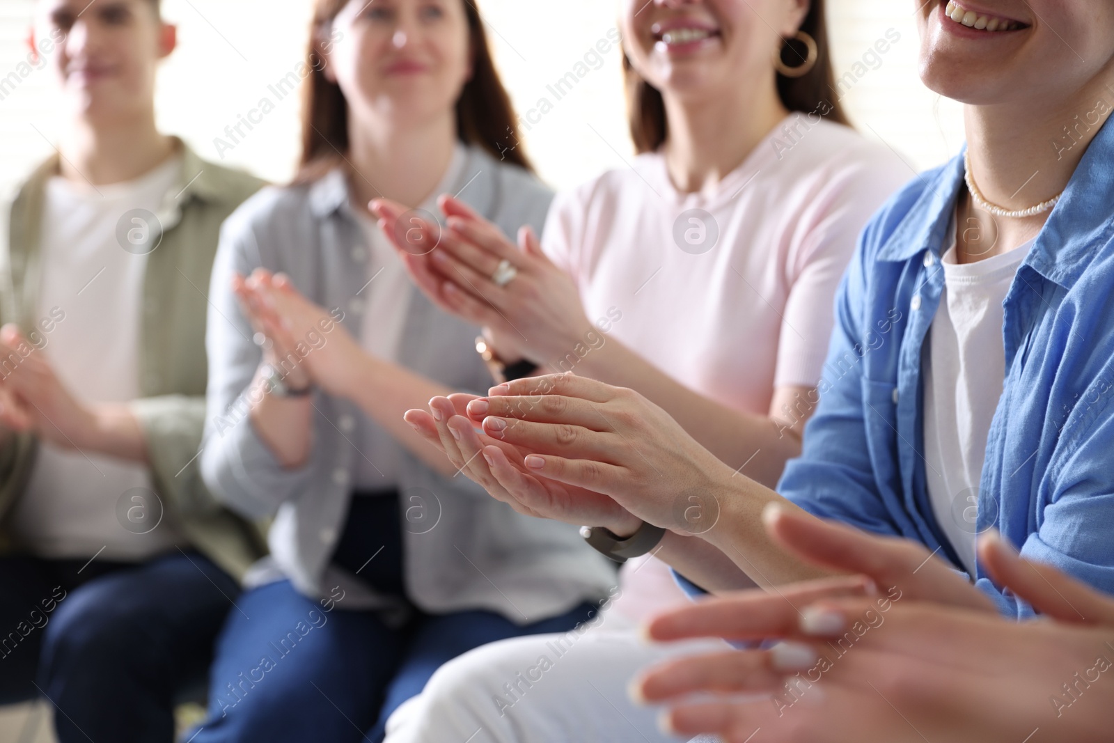 Photo of People applauding during meeting indoors, closeup view