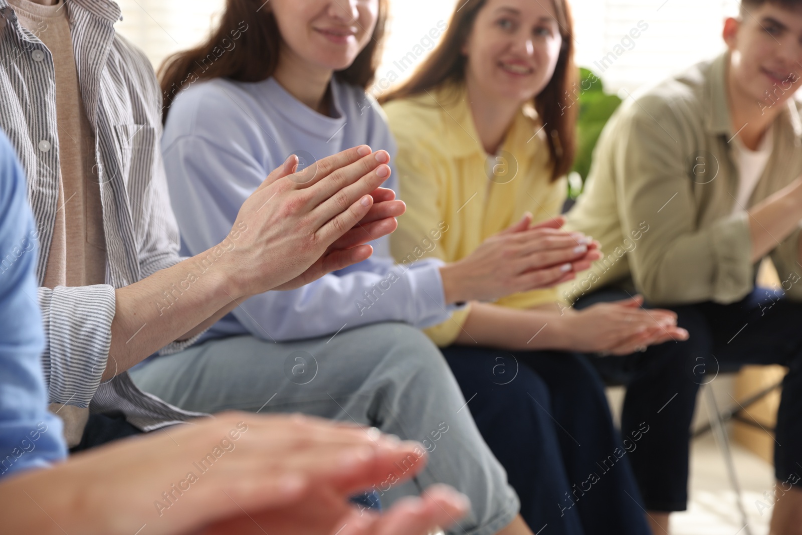 Photo of People applauding during meeting indoors, closeup view