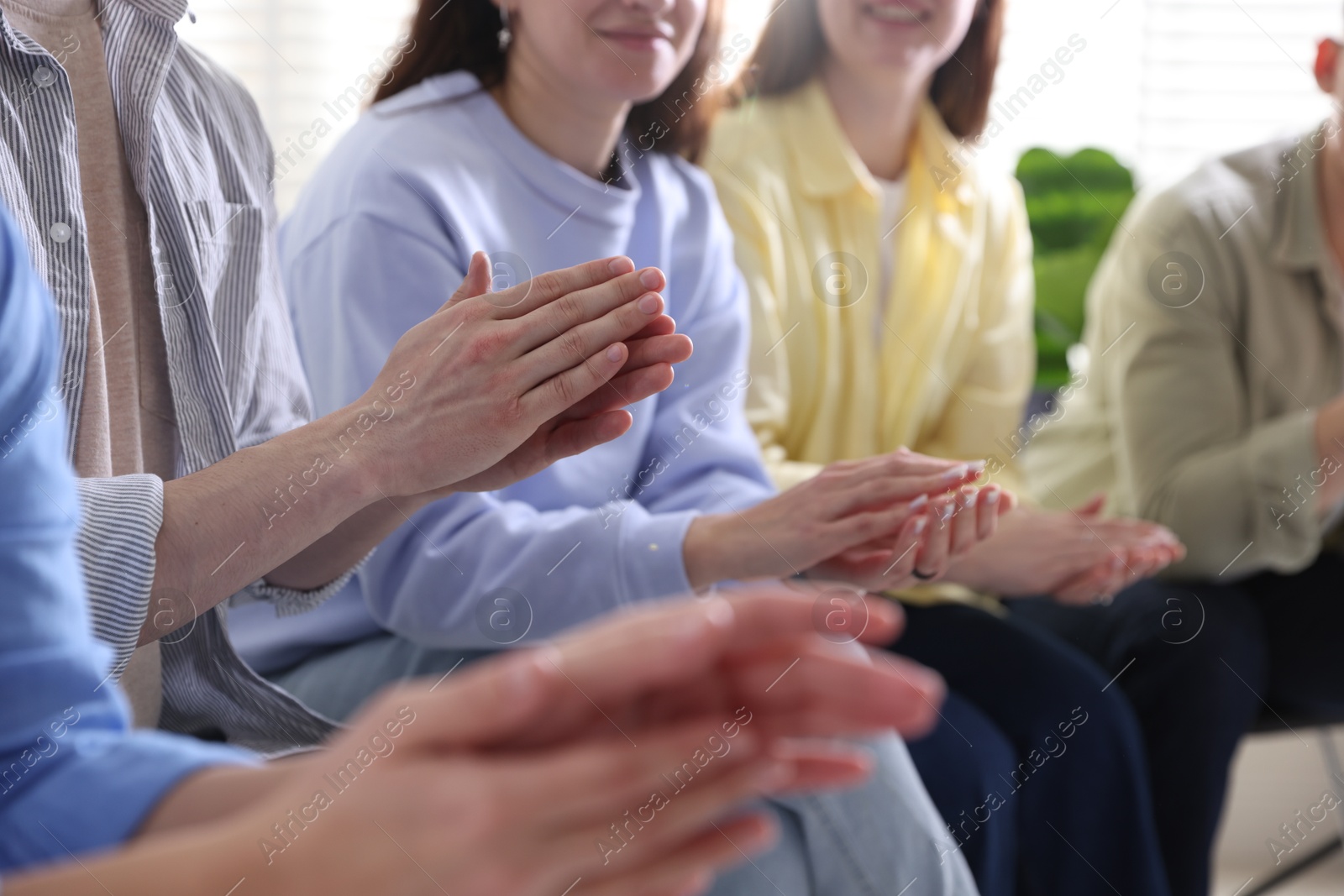 Photo of People applauding during meeting indoors, closeup view