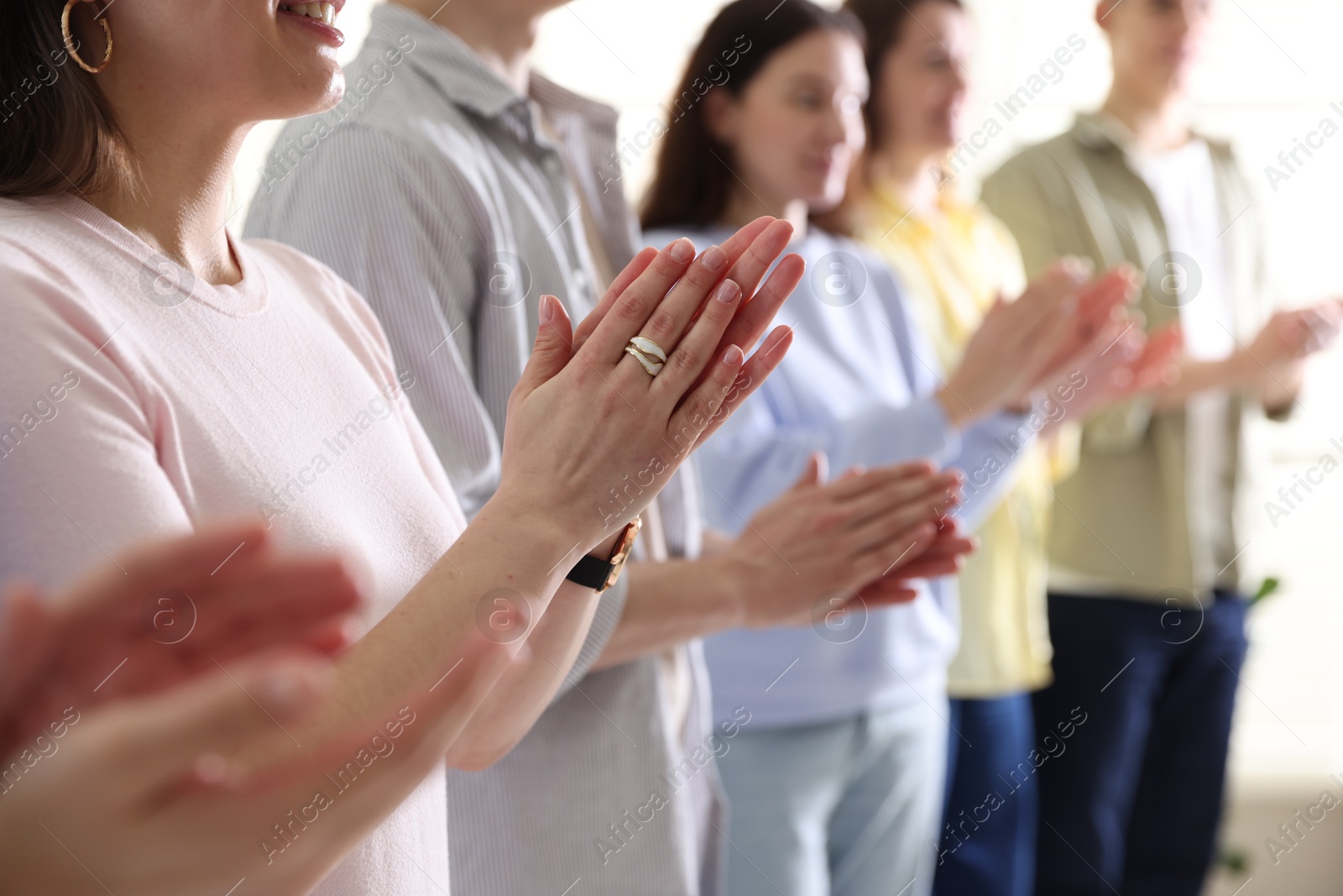 Photo of People applauding during meeting indoors, closeup view