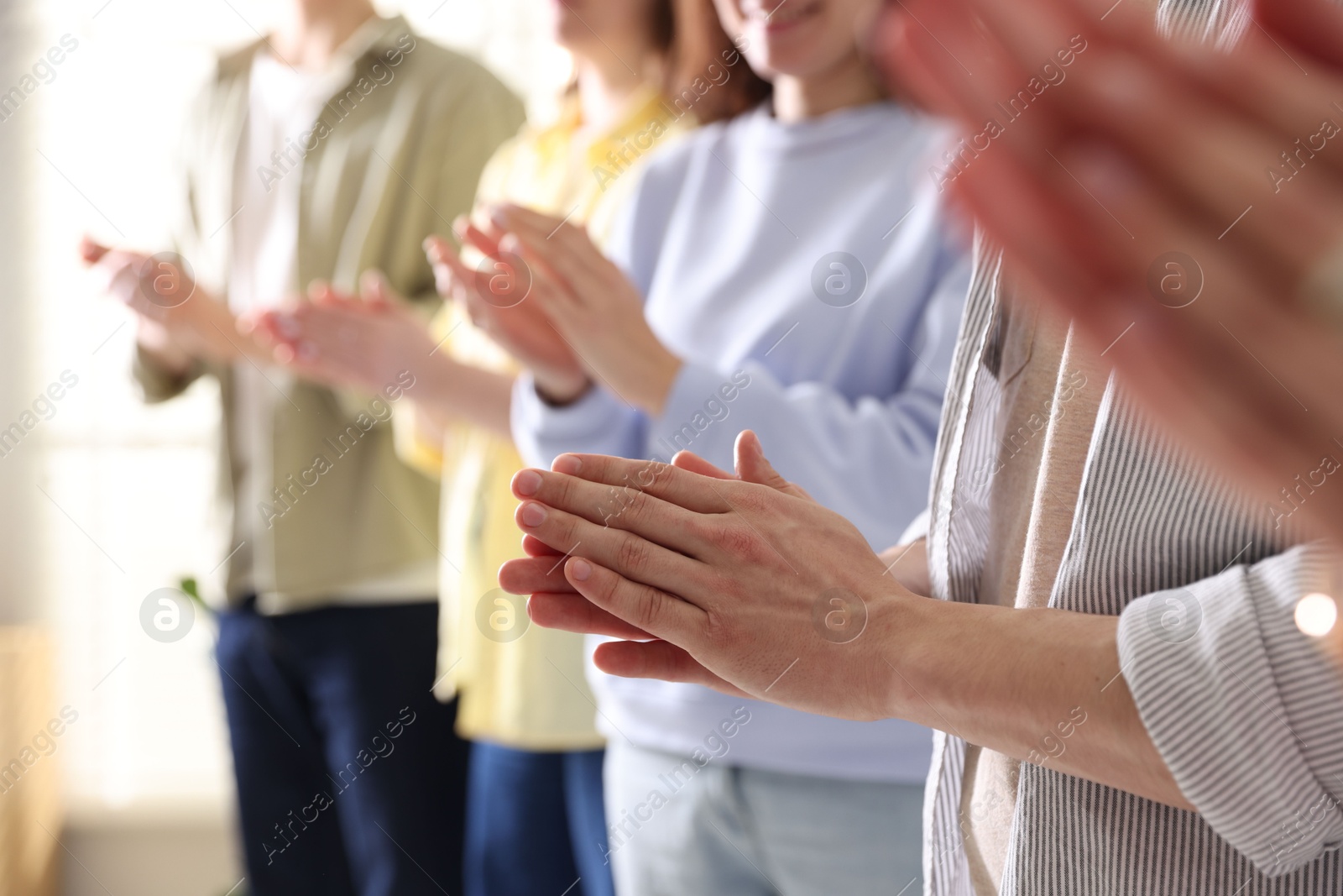 Photo of People applauding during meeting indoors, closeup view