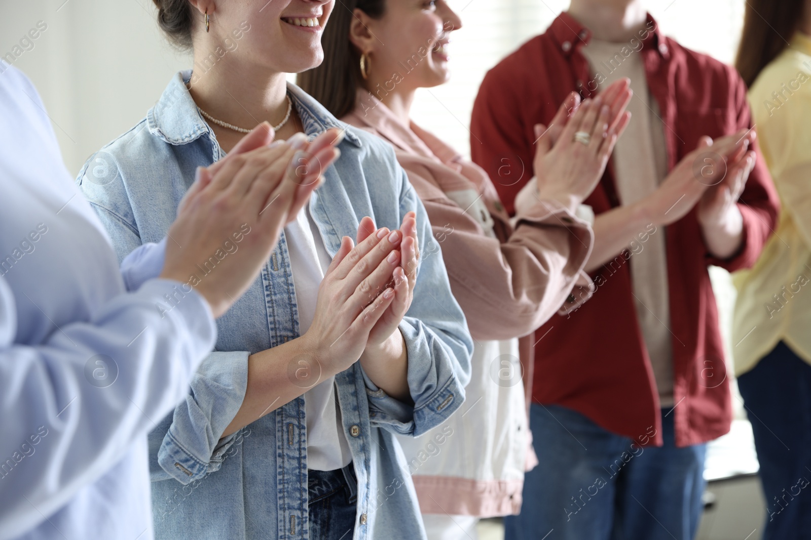 Photo of People applauding during meeting indoors, closeup view