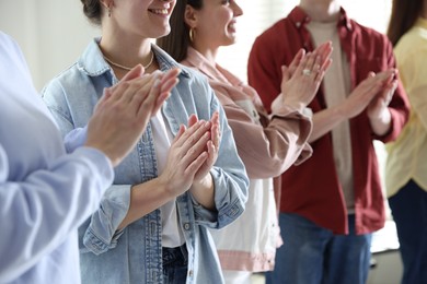 Photo of People applauding during meeting indoors, closeup view