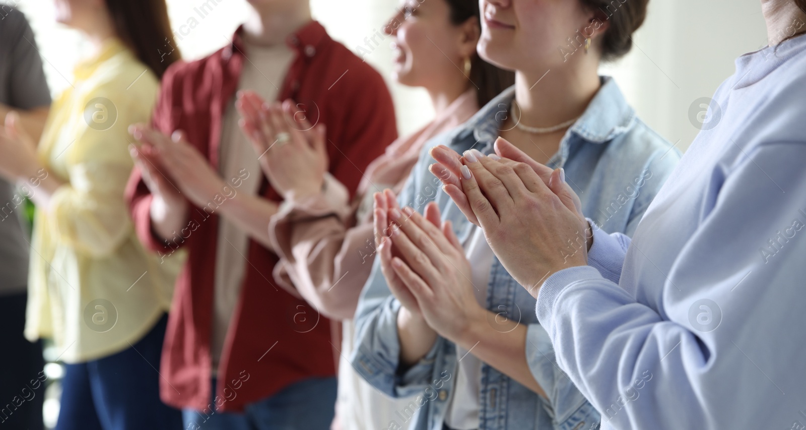 Photo of People applauding during meeting indoors, closeup view