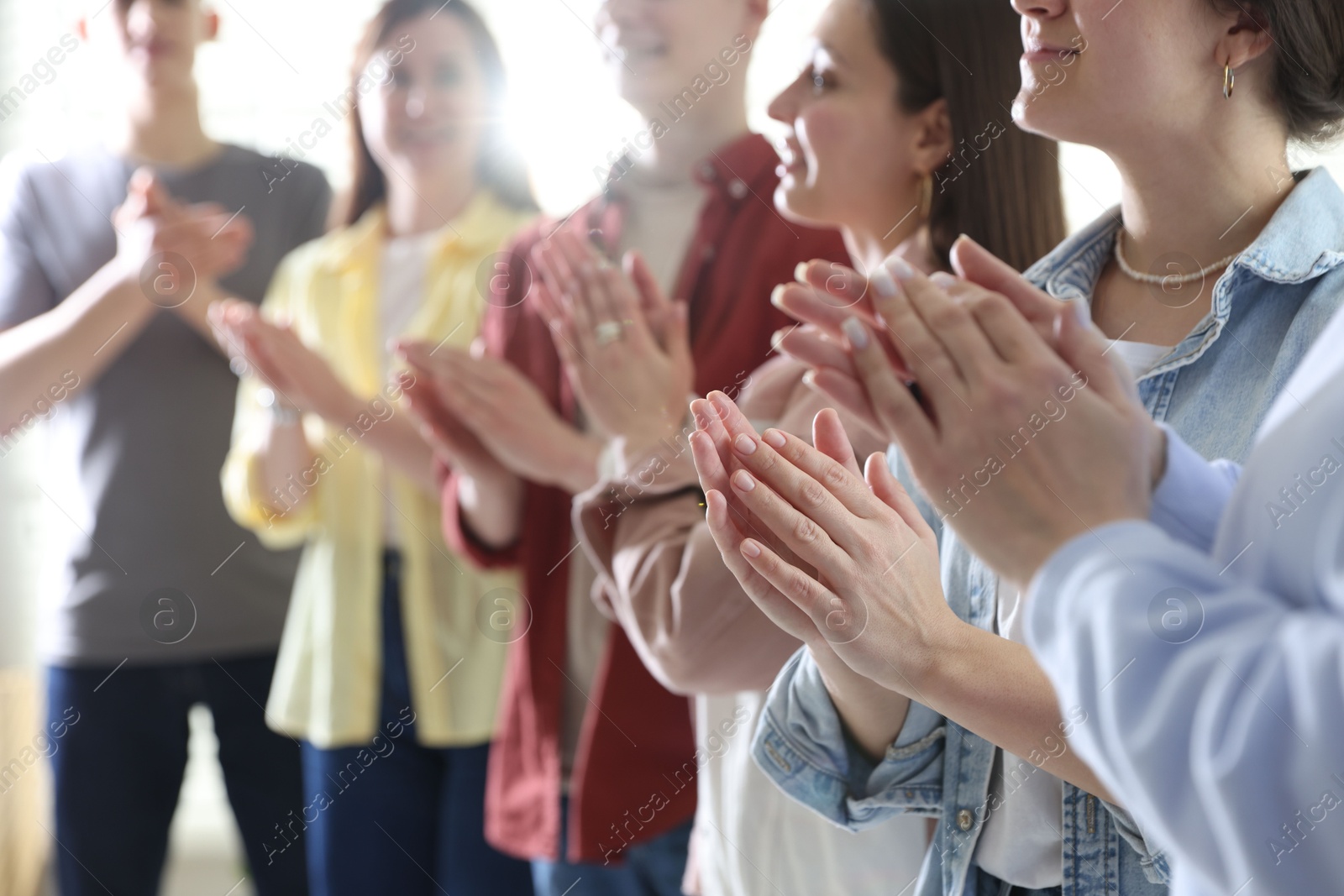 Photo of People applauding during meeting indoors, closeup view