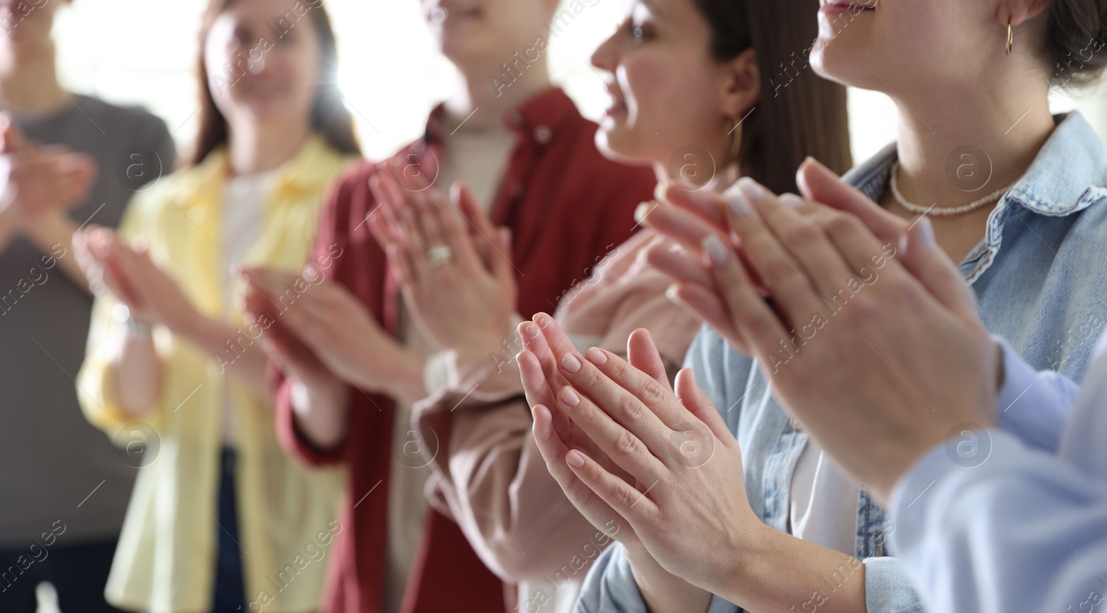 Photo of People applauding during meeting indoors, closeup view