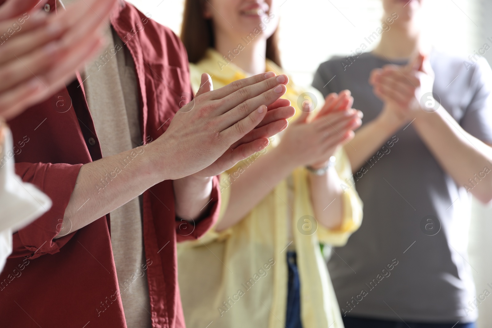 Photo of People applauding during meeting indoors, closeup view