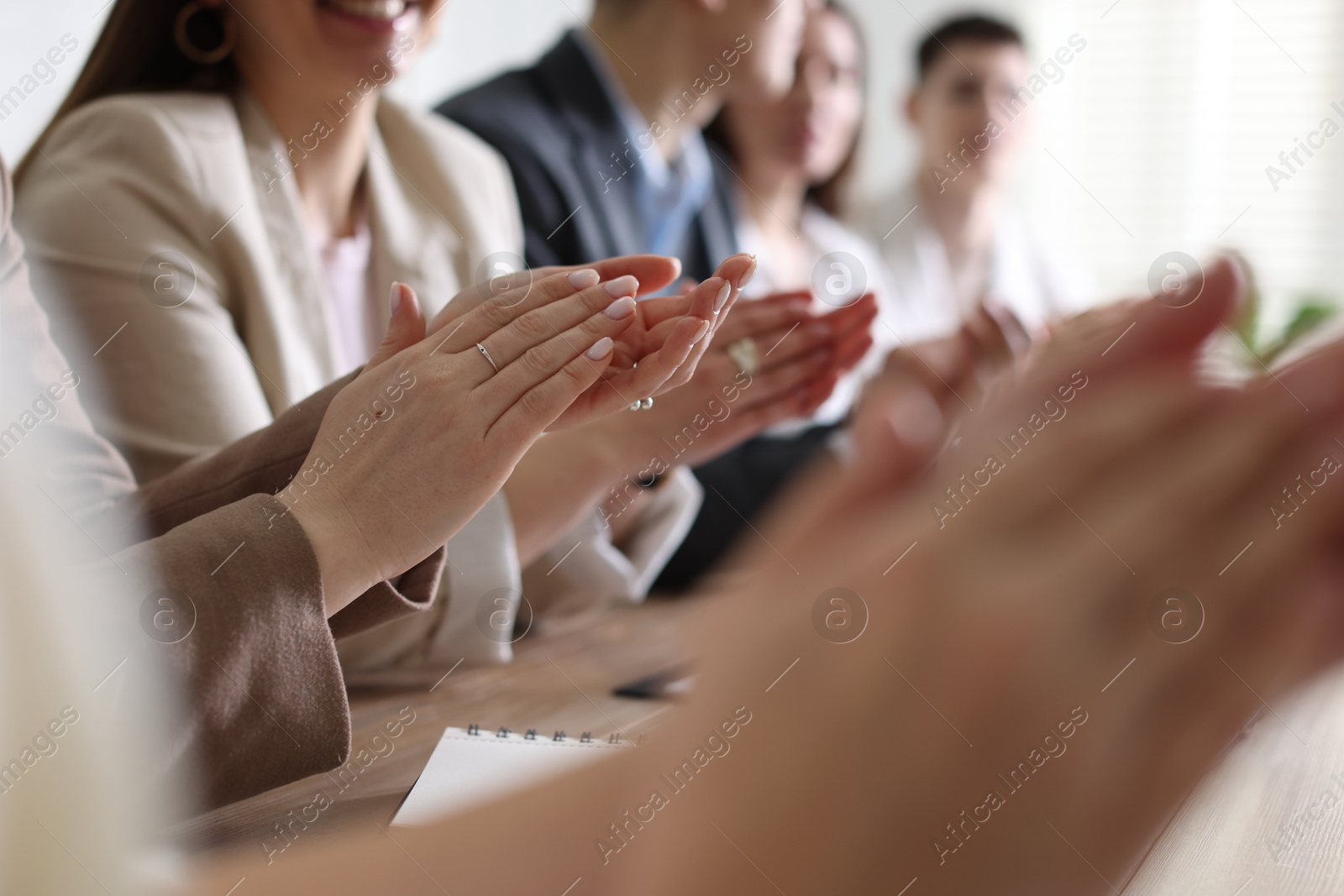 Photo of People applauding at table in office, closeup