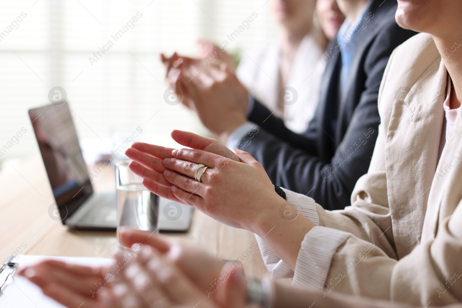 Photo of People applauding at table in office, closeup