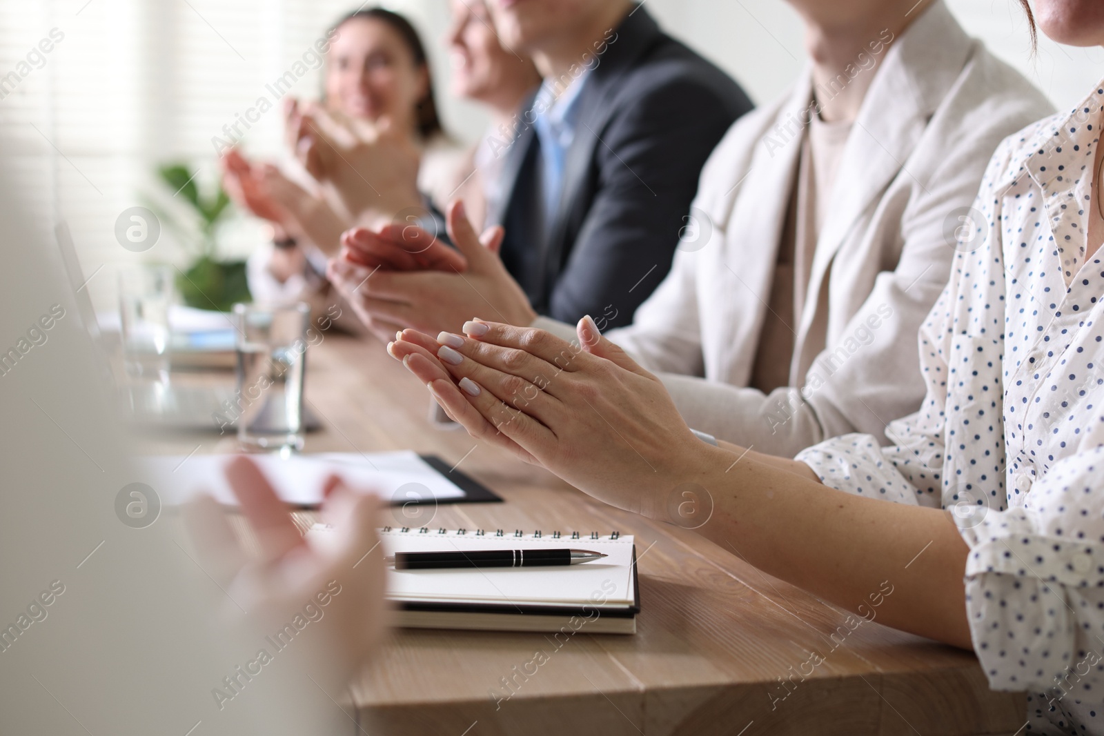 Photo of People applauding at table in office, closeup