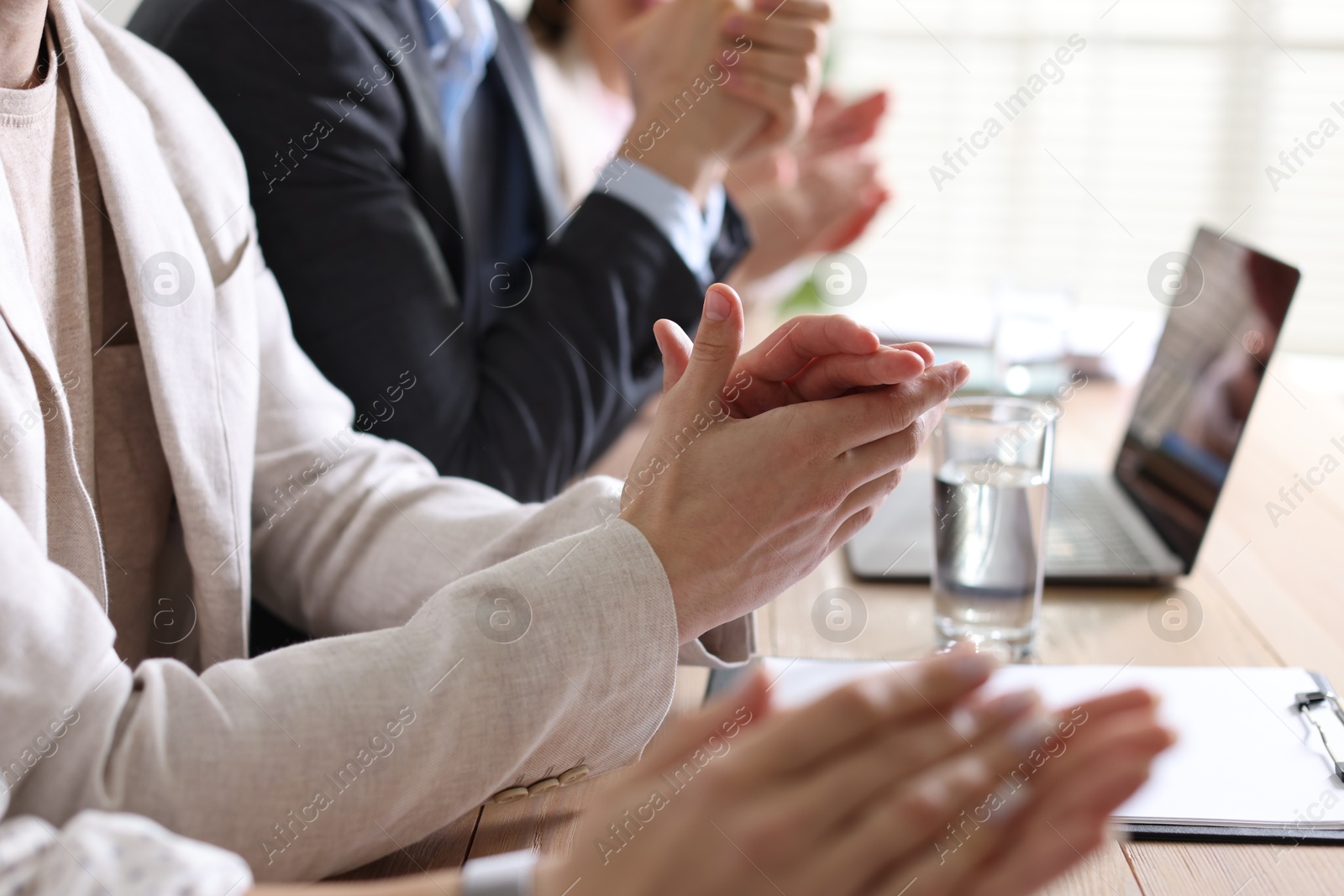 Photo of People applauding at table in office, closeup