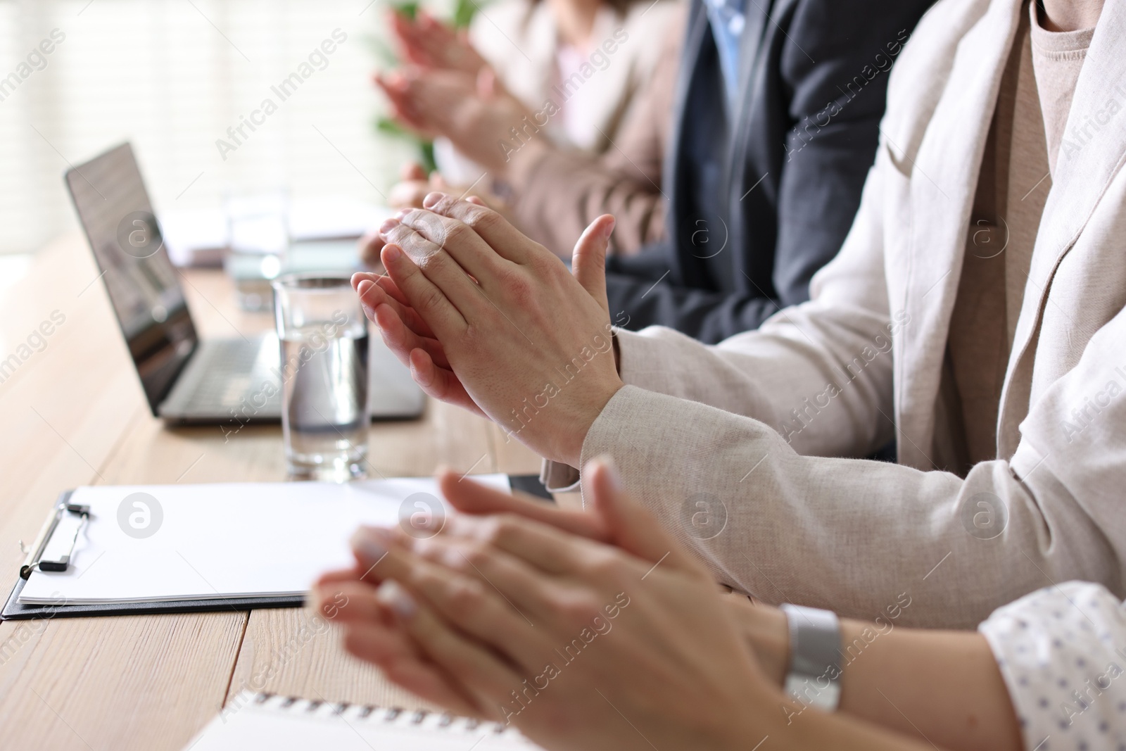 Photo of People applauding at table in office, closeup