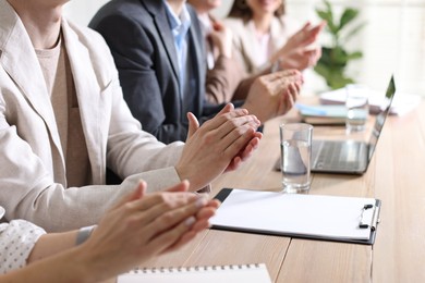 Photo of People applauding at table in office, closeup