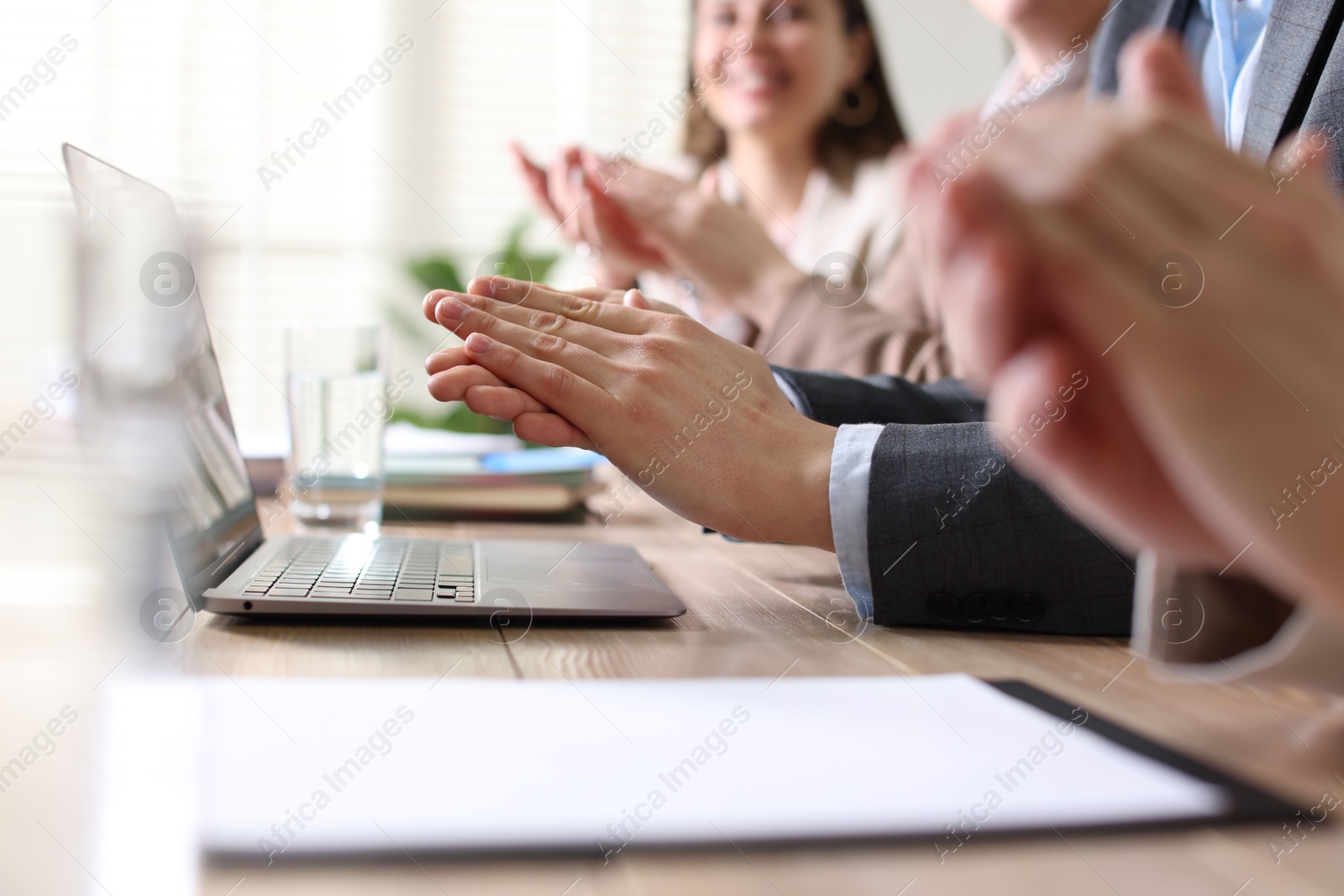 Photo of People applauding at table in office, closeup