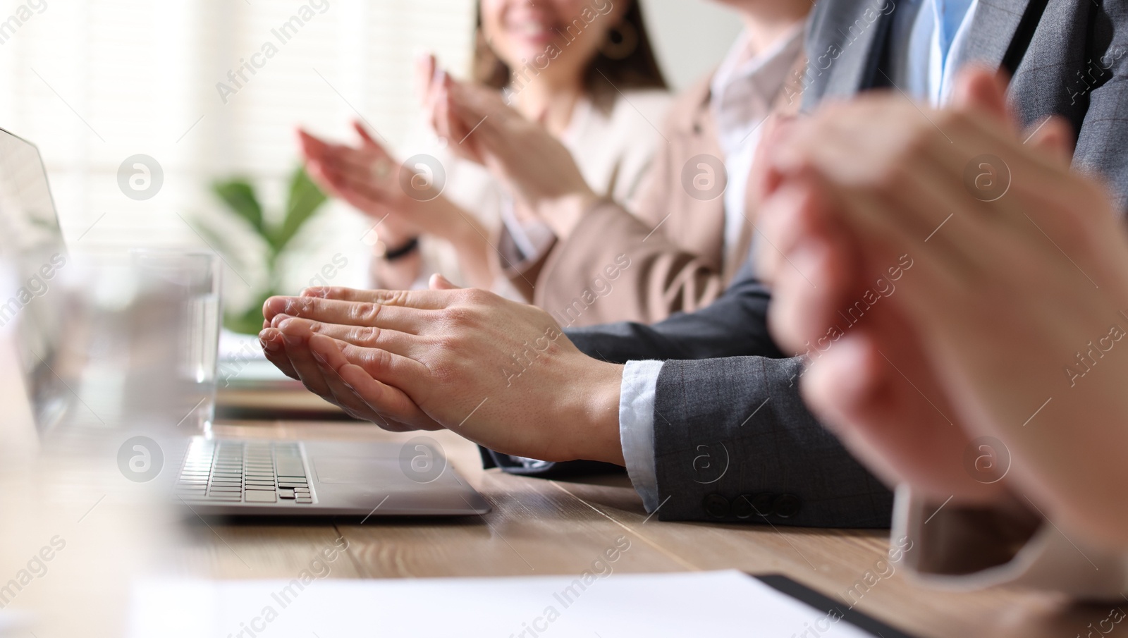 Photo of People applauding at table in office, closeup