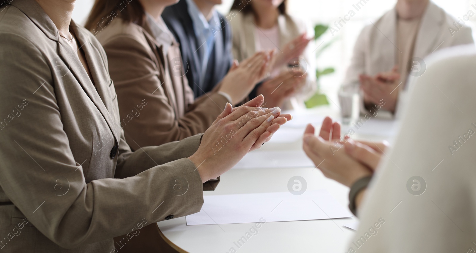 Photo of People applauding at table in office, closeup