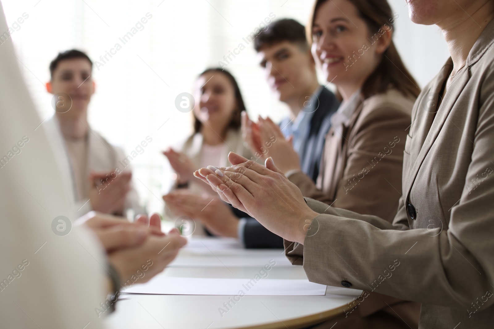 Photo of People applauding at table in office, closeup