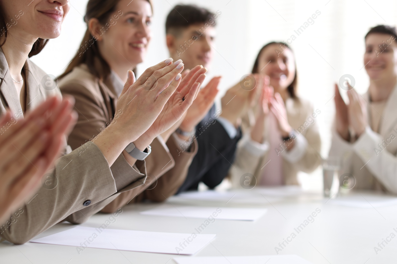 Photo of People applauding at table in office, closeup